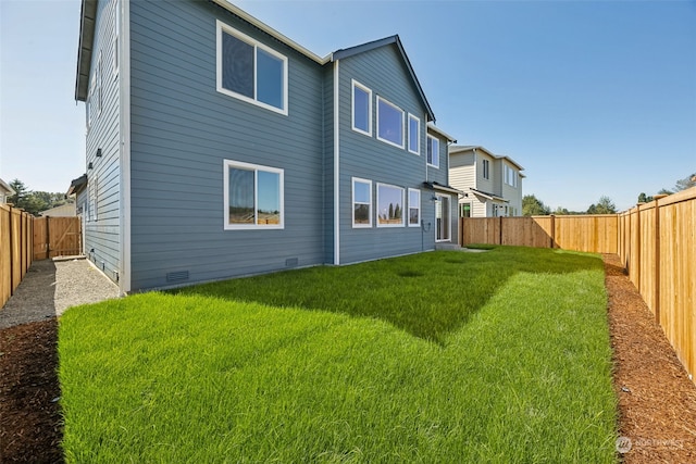 rear view of house featuring a yard