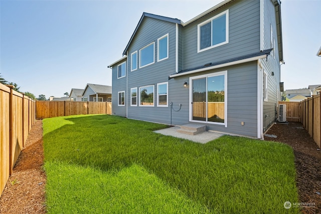 rear view of property with a lawn