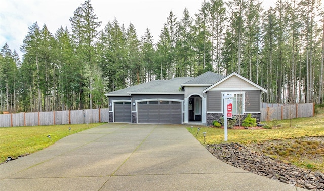 view of front of house featuring a garage and a front yard