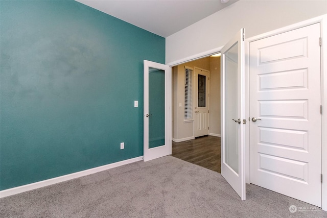 unfurnished bedroom with carpet and french doors