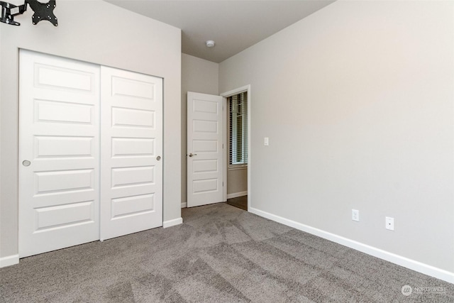 unfurnished bedroom with carpet floors and a closet