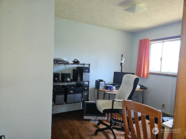 office space with dark wood-type flooring and a textured ceiling