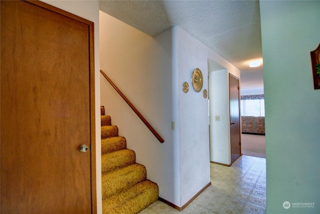 stairway with a textured ceiling