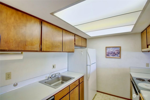 kitchen with sink and white fridge