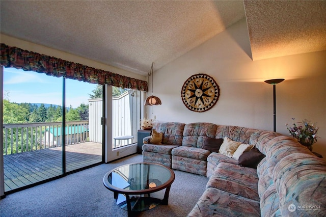 living room with lofted ceiling, a textured ceiling, and carpet floors