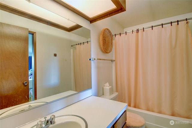 full bathroom with vanity, shower / bathtub combination with curtain, and toilet