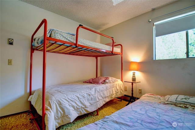 carpeted bedroom with a textured ceiling