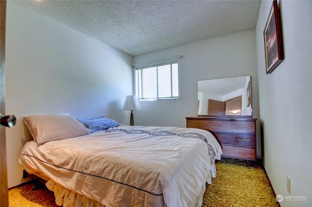 bedroom featuring a textured ceiling and light carpet