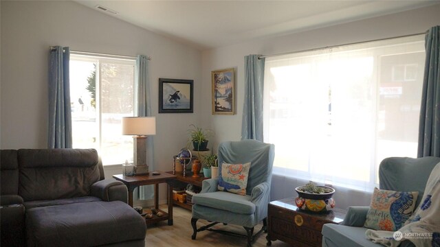 living area featuring light hardwood / wood-style flooring and lofted ceiling