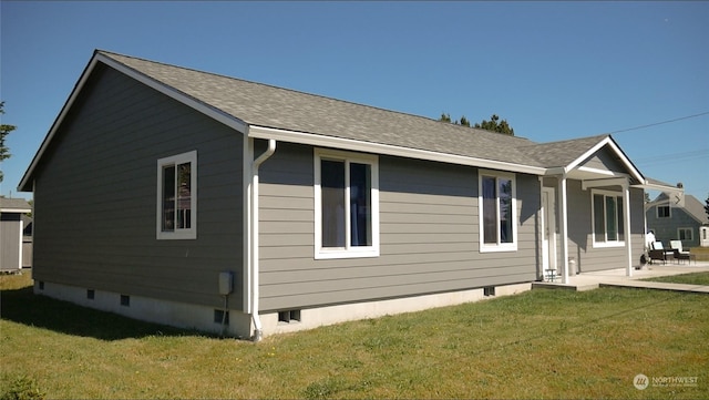 view of front of home with a front yard and a patio area