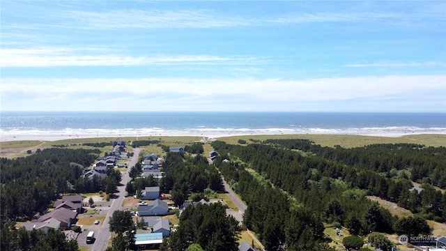 birds eye view of property with a water view and a view of the beach