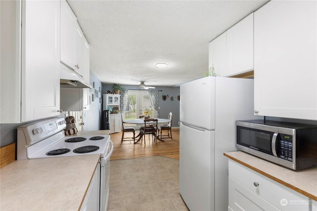 kitchen featuring white cabinetry, ceiling fan, white appliances, and a textured ceiling