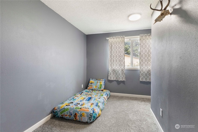 bedroom featuring carpet floors and a textured ceiling