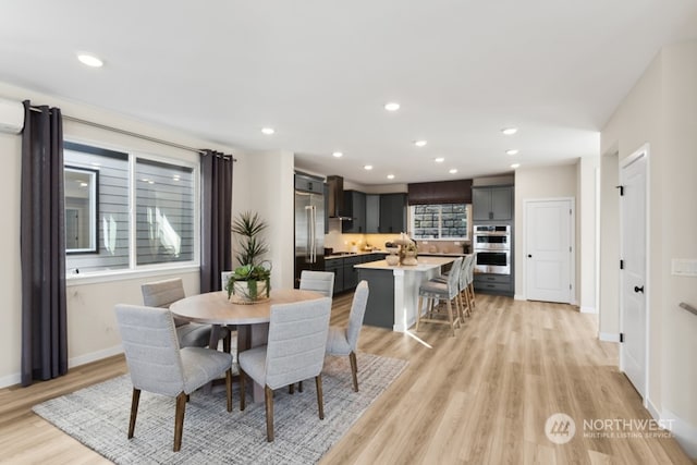 dining space with light hardwood / wood-style floors