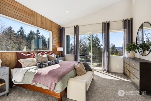 bedroom with wooden walls, lofted ceiling, and carpet flooring