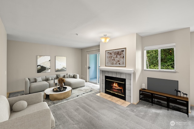 living room with light colored carpet and a tile fireplace