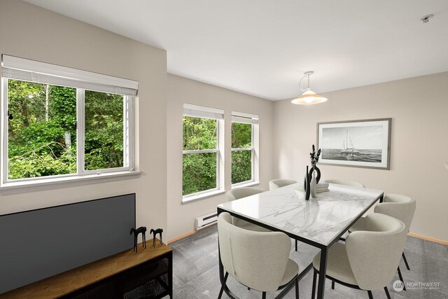 carpeted dining space with baseboard heating and plenty of natural light