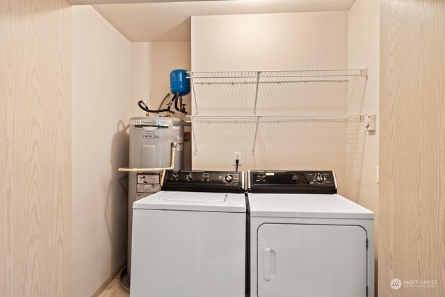 washroom featuring electric water heater and independent washer and dryer