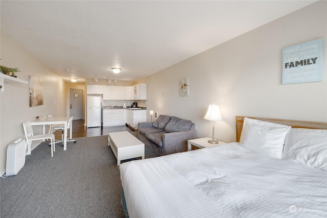 bedroom with freestanding refrigerator