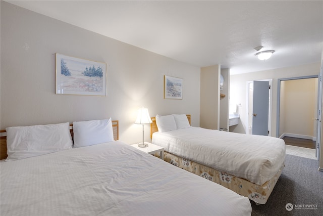 bedroom featuring hardwood / wood-style flooring and ensuite bathroom