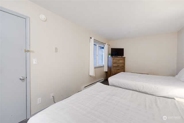 bedroom with a baseboard heating unit