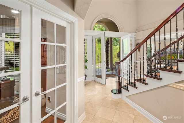 tiled foyer entrance featuring french doors