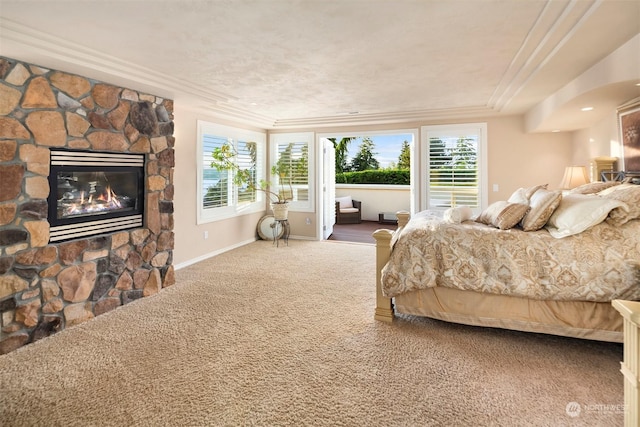 bedroom featuring a fireplace, carpet floors, and ornamental molding