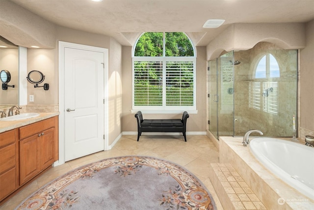 bathroom featuring tile patterned flooring, vanity, and independent shower and bath