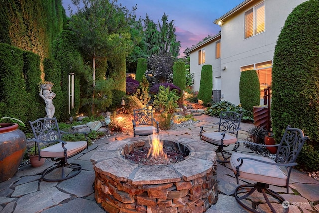 patio terrace at dusk with a fire pit