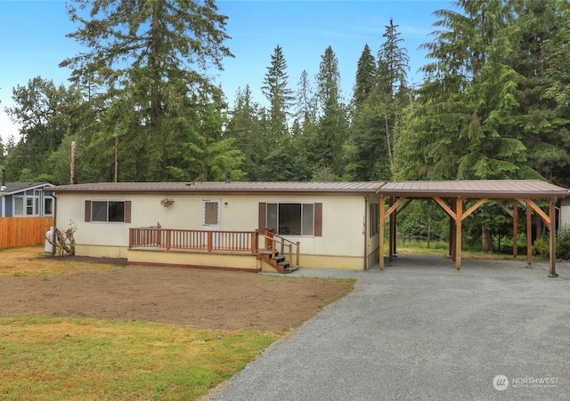 view of front of house featuring a deck and a carport