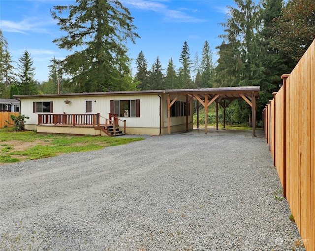 view of front of property featuring a deck and a carport