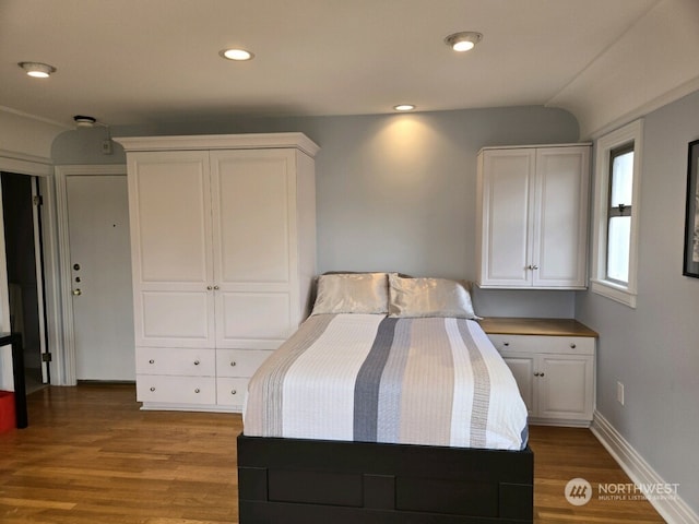 bedroom with hardwood / wood-style flooring