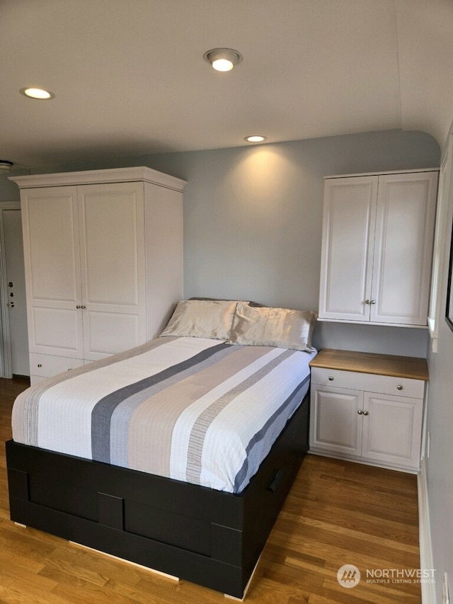 bedroom with wood-type flooring