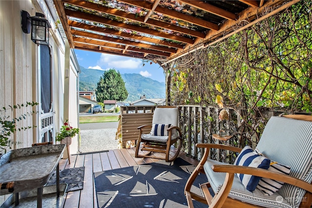 wooden terrace with a mountain view and a pergola