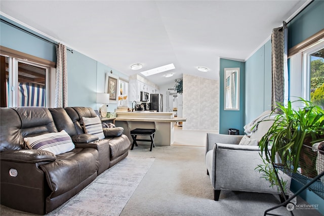 carpeted living area featuring vaulted ceiling and a sink