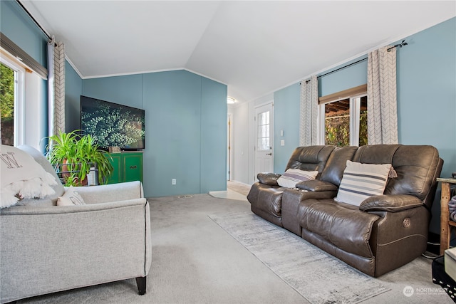 living area featuring lofted ceiling and carpet flooring