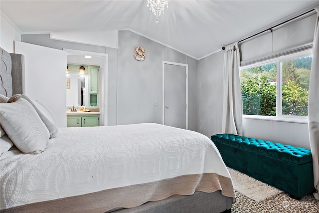 bedroom with lofted ceiling, crown molding, ensuite bathroom, and a sink