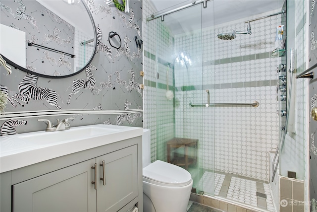 full bathroom with a shower stall, toilet, and vanity