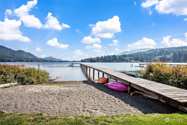 view of dock with a water and mountain view