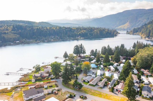 aerial view with a residential view, a wooded view, and a water and mountain view