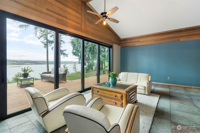 sunroom / solarium featuring a water view, vaulted ceiling, and ceiling fan