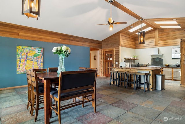 dining area featuring beam ceiling, ceiling fan, and high vaulted ceiling