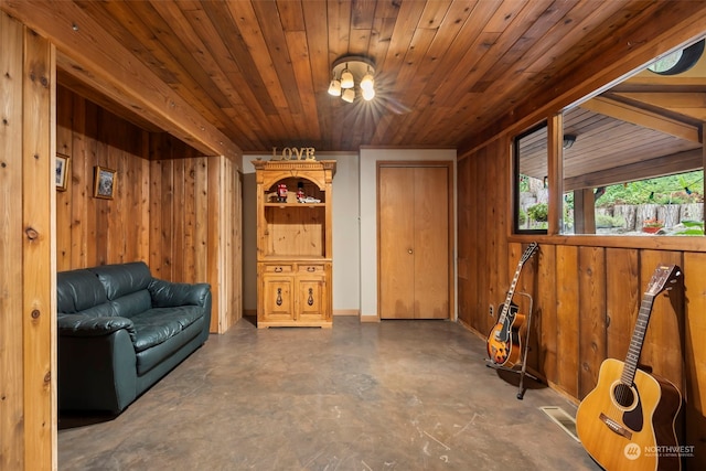 living area featuring wooden ceiling and wooden walls