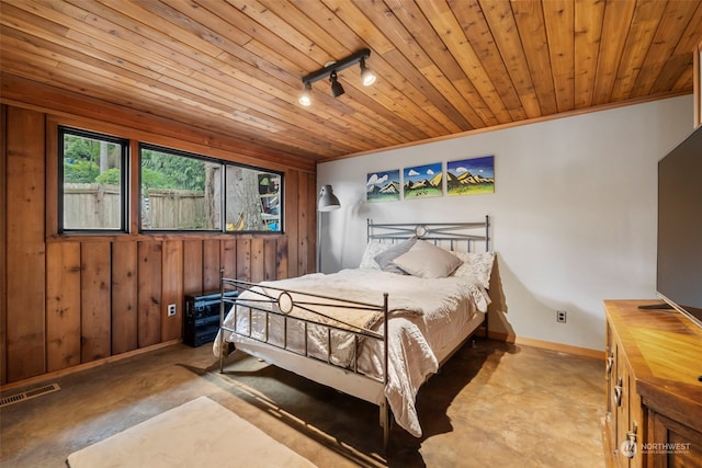 bedroom featuring wooden walls, crown molding, rail lighting, and wood ceiling