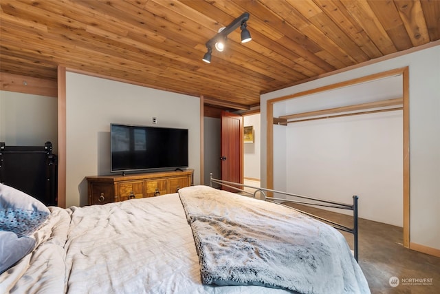 bedroom with rail lighting, a closet, and wooden ceiling