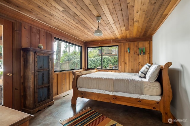 bedroom with wood walls and wood ceiling