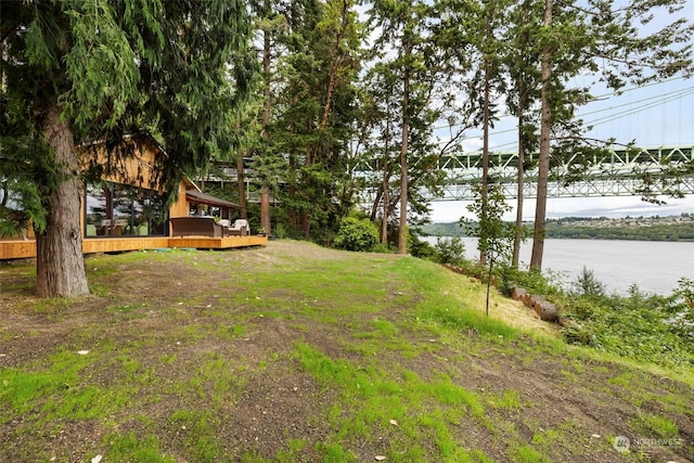 view of yard featuring a deck with water view