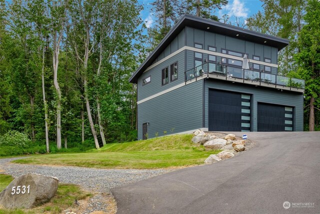 view of side of home featuring a garage and a yard