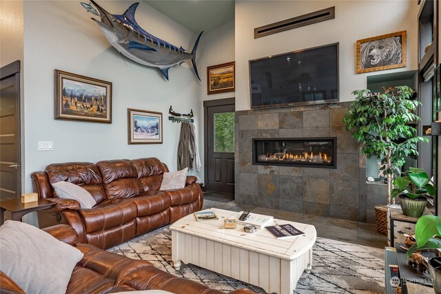 tiled living room featuring tile walls and a tiled fireplace