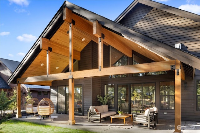 back of house featuring a patio area and an outdoor living space